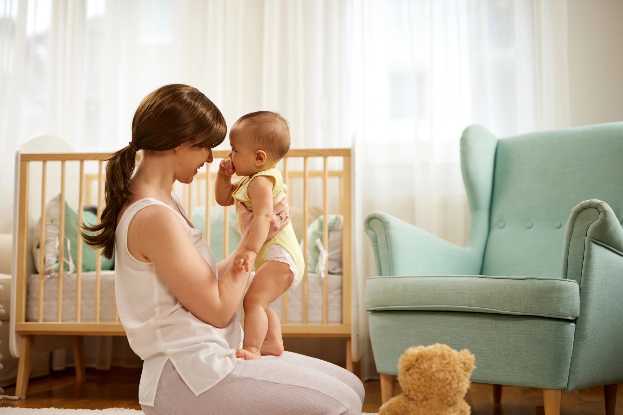 Mother holding baby at home