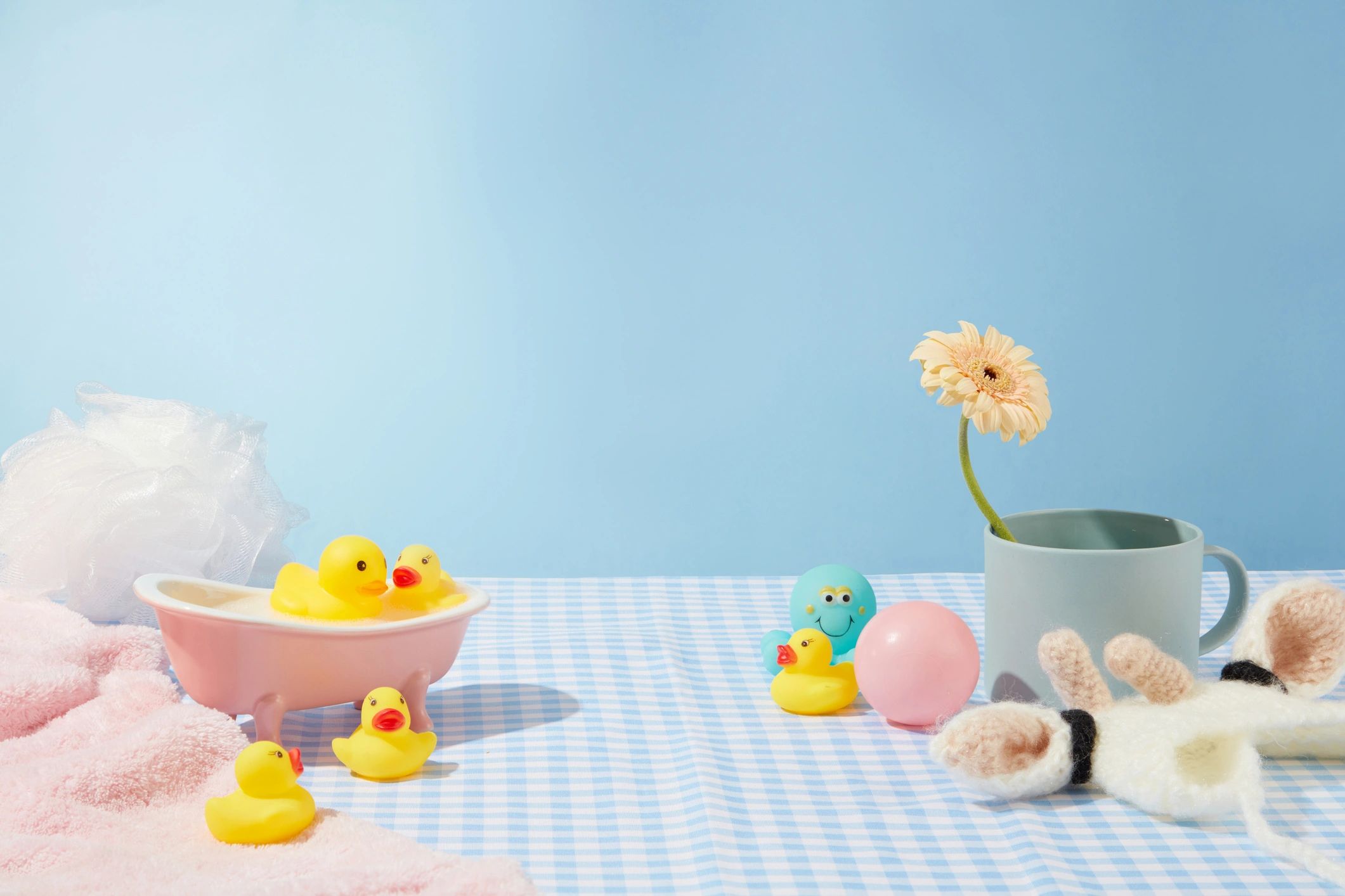 Baby bath products arranged on a light blue background
