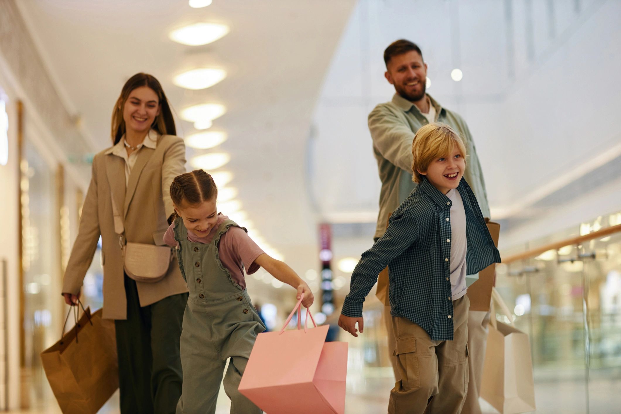 Happy family shopping with children and gift bags