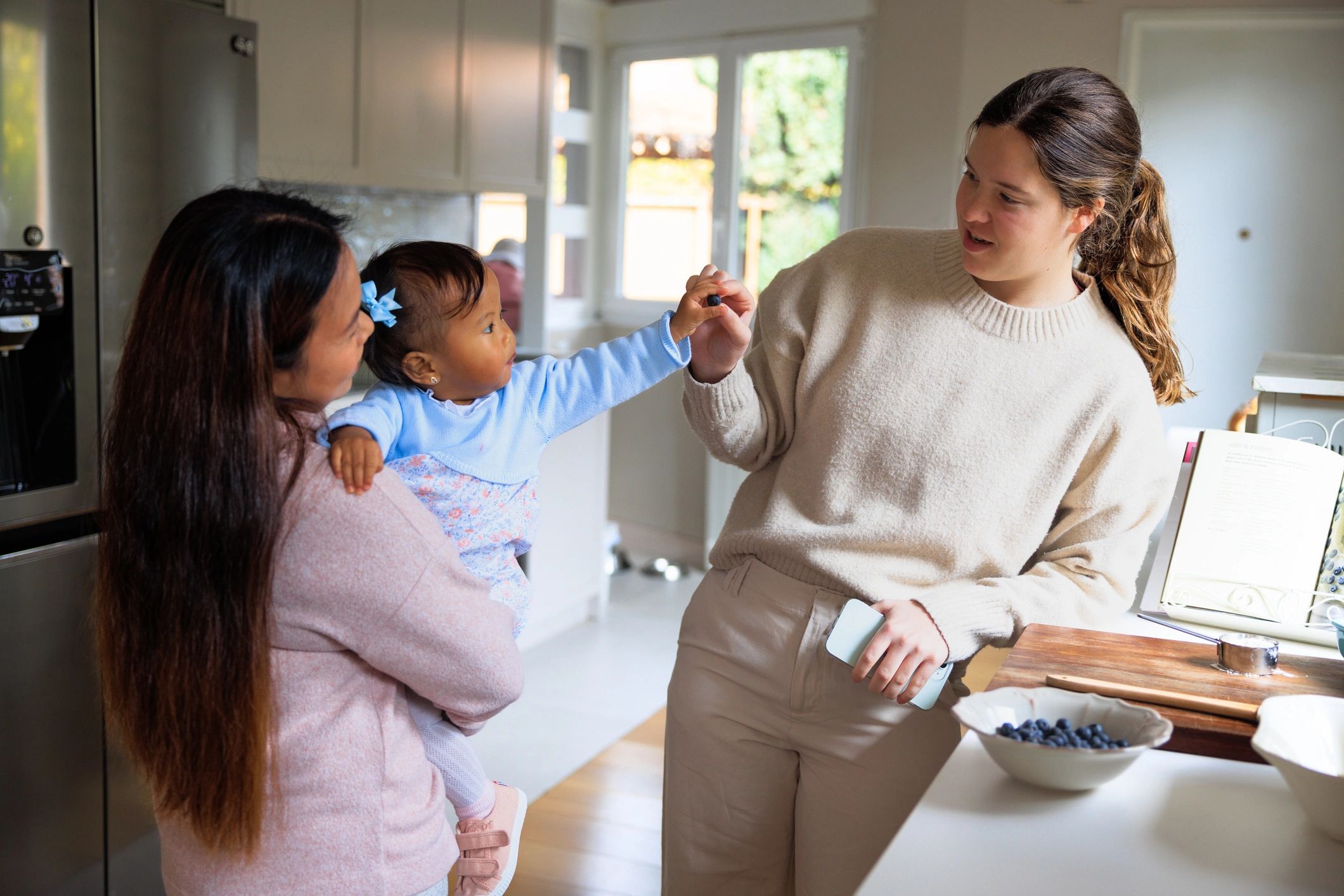 Toddler enjoying a healthy snack with family