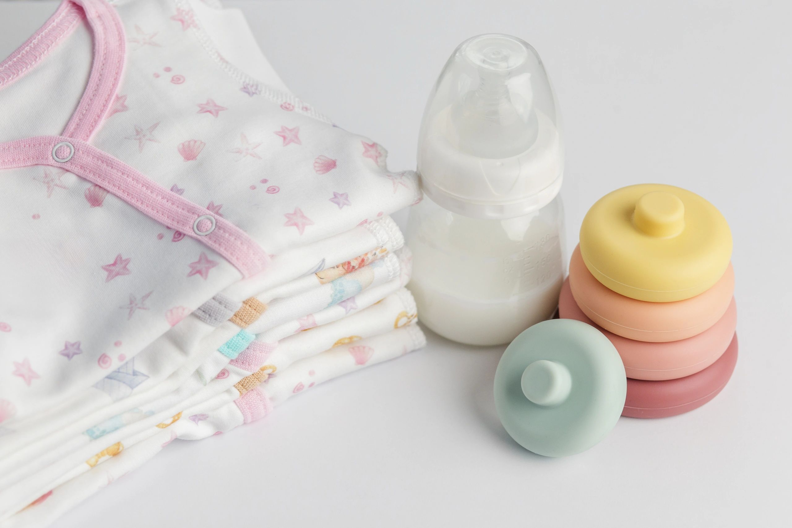 Baby feeding bottle and infant essentials on a white background